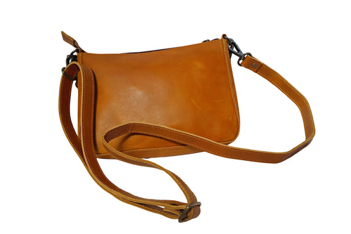 Brown leather shoulder bag on a white background