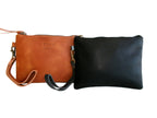 Two leather wrist strap pouches, one in black and one in brown, with brass hardware and detachable straps displayed against a white background.